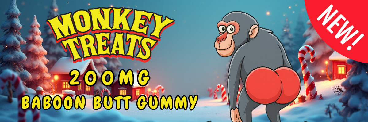 Monkey Treats 200mg Baboon Butt Gummy promotional banner with cartoon monkey in winter setting, featuring candy canes and holiday-themed background, labeled "NEW!"